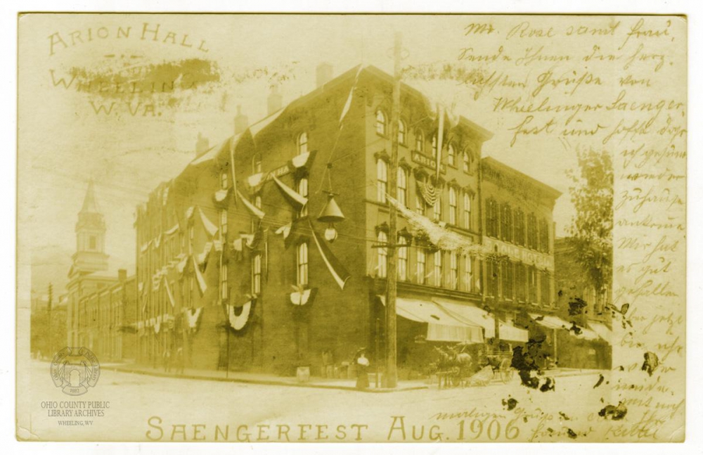 Arion Hall at 20th and Main Streets is decorated for the 1906 Saengerfest parade in this real photo postcard. Ohio County Public Library Archives.