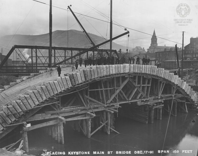 W.C. Brown Photo Collection: Placing the Keystone on the Main St. Bridge, Dec 17, 1891