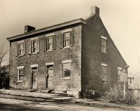 Double house supposed to have been built by the Zane brothers in 1837, for the toll keepers of the wooden bridge that spanned the back river. It stood on Zane Street.