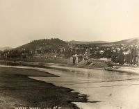 The river front around 8th Street showing the old Wheeling water works that stood on the bank.