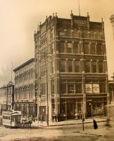 The old Opera House was erected in 1873. Many famous actors and singers appeared here. The Reilly building stands out front on this corner, 14th and Market Streets. It was built in 1886. Note the mule team hitched to the street car coming around the corner.