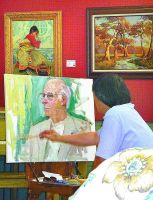 Master artist Yan Sun, native of China, paints a portrait of Marc Harshman at Centre Market. The original painting can be viewed in the Wheeling Room. (Photo by Linda Comins)