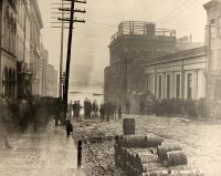The flood of 1884 covered 12th and Main Streets and did enormous damage to commercial establishments. Notice the hundreds of wires leading into the roof of the telephone exchange on the top floor of the People's Bank.