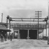 BROWN PHOTO #16: The Bridgeport entrance to the covered bridge over the back river. Notice the raised railroad crossing gate in the center.